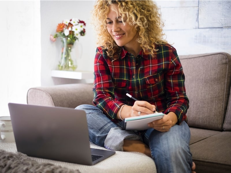 Woman working on laptop - become an Alvva affiliate partner